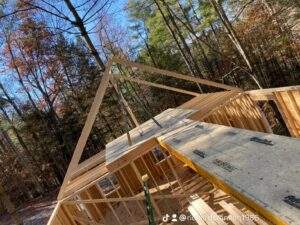 Cabin construction in the Red River Gorge, Kentucky. Framing and flooring are complete on this custom built home, nestled in a dense forest. Build your dream cabin with our expert team.